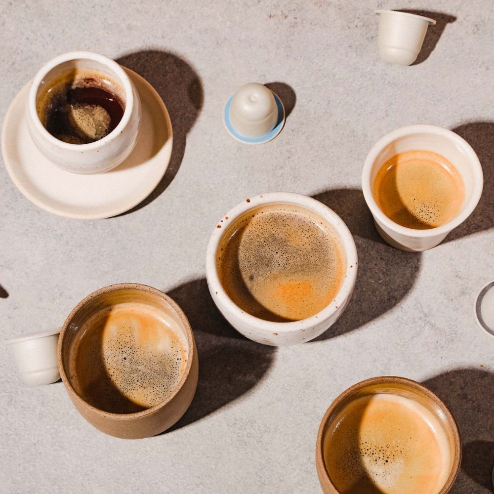 The Best Coffee Pod Subscriptions UK 2026 (Top 8) 8 Cups of espresso made with Origin capsules on a stone surface