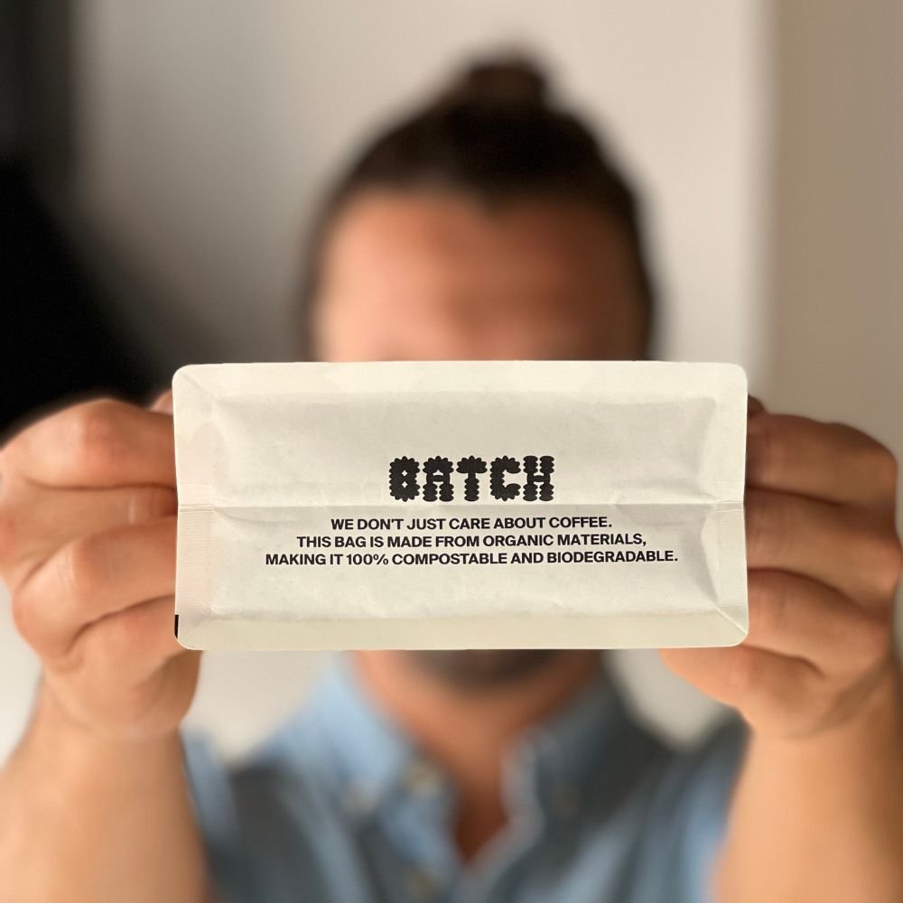 Tomholdingsustainablecoffeebeansfortheoffice Sustainable Coffee Practices for the Office