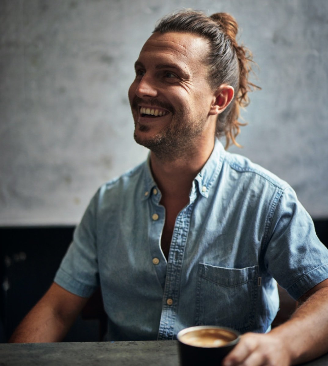 Why Is Coffee So Expensive Right Now? A Roaster Explains 5 Tom Saxon, founder of Batch Coffee Club, smiling with a cup of coffee