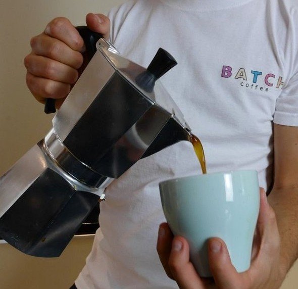 Tom Saxon of Batch Coffee pouring coffee from a moka pot